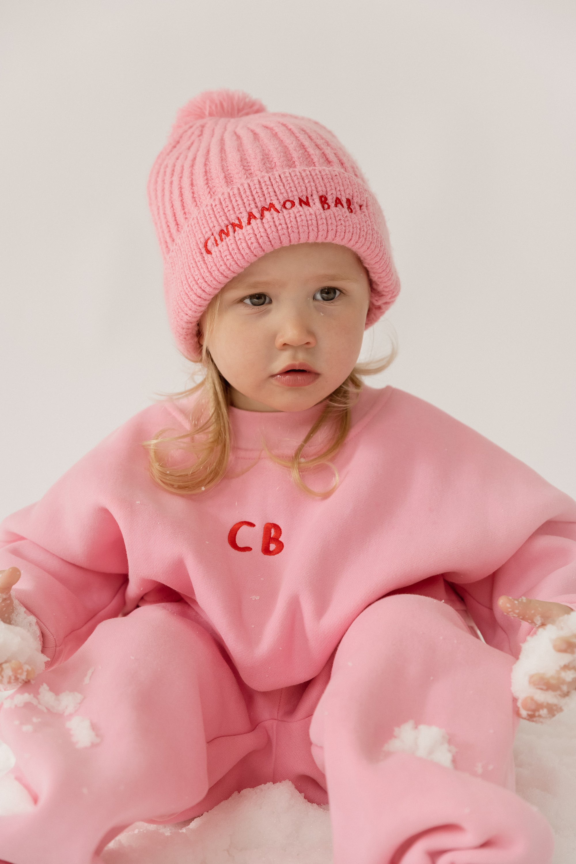 Cinnamon baby tracksuit with fairy floss pink accents, soft cotton blend unisex toddler outfit for comfy everyday wear.