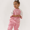 Cinnamon baby raglan tee with pink fairy floss sleeves – soft cotton toddler shirt for stylish everyday wear.