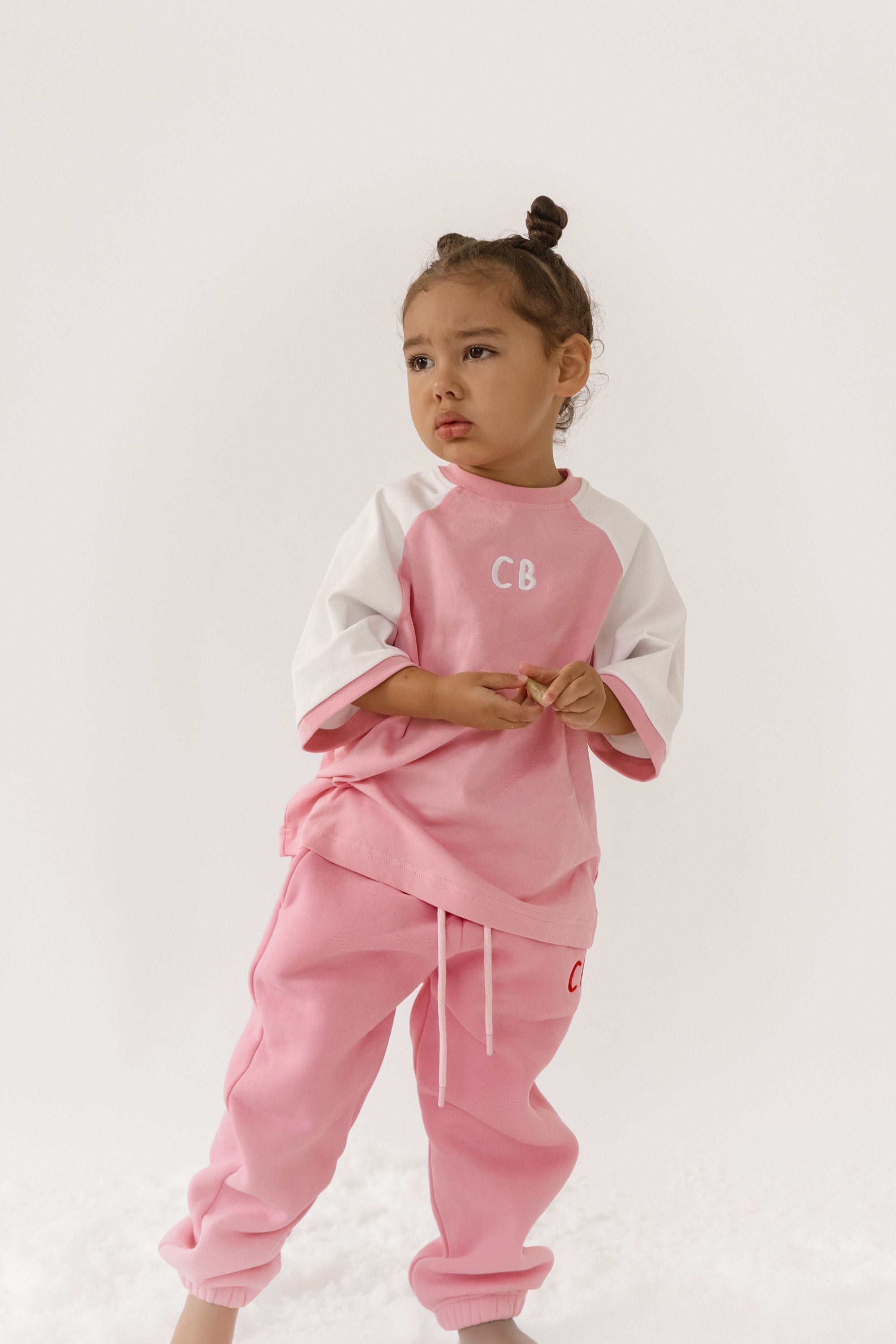 Cinnamon baby raglan tee with pink fairy floss sleeves – soft cotton toddler shirt for stylish everyday wear.
