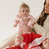 Cinnamon baby growsuit in fairy floss pink with smiley face print, soft cotton one-piece outfit for comfortable toddler wear.