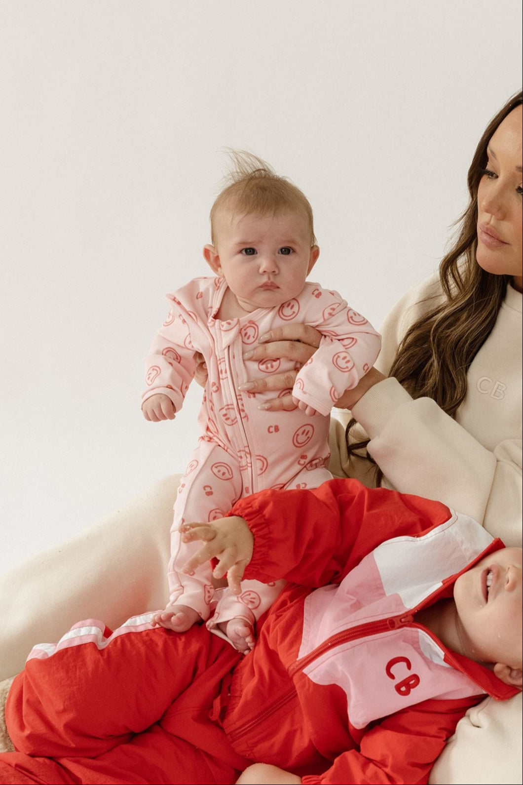 Cinnamon baby growsuit in fairy floss pink with smiley face print, soft cotton one-piece outfit for comfortable toddler wear.
