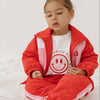 Cinnamon baby tee with white sleeves and smiley face print – unisex cotton toddler t-shirt for everyday comfort and style.