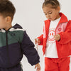 Cinnamon baby tee with white sleeves and smiley face print – unisex cotton toddler t-shirt for everyday comfort and style.