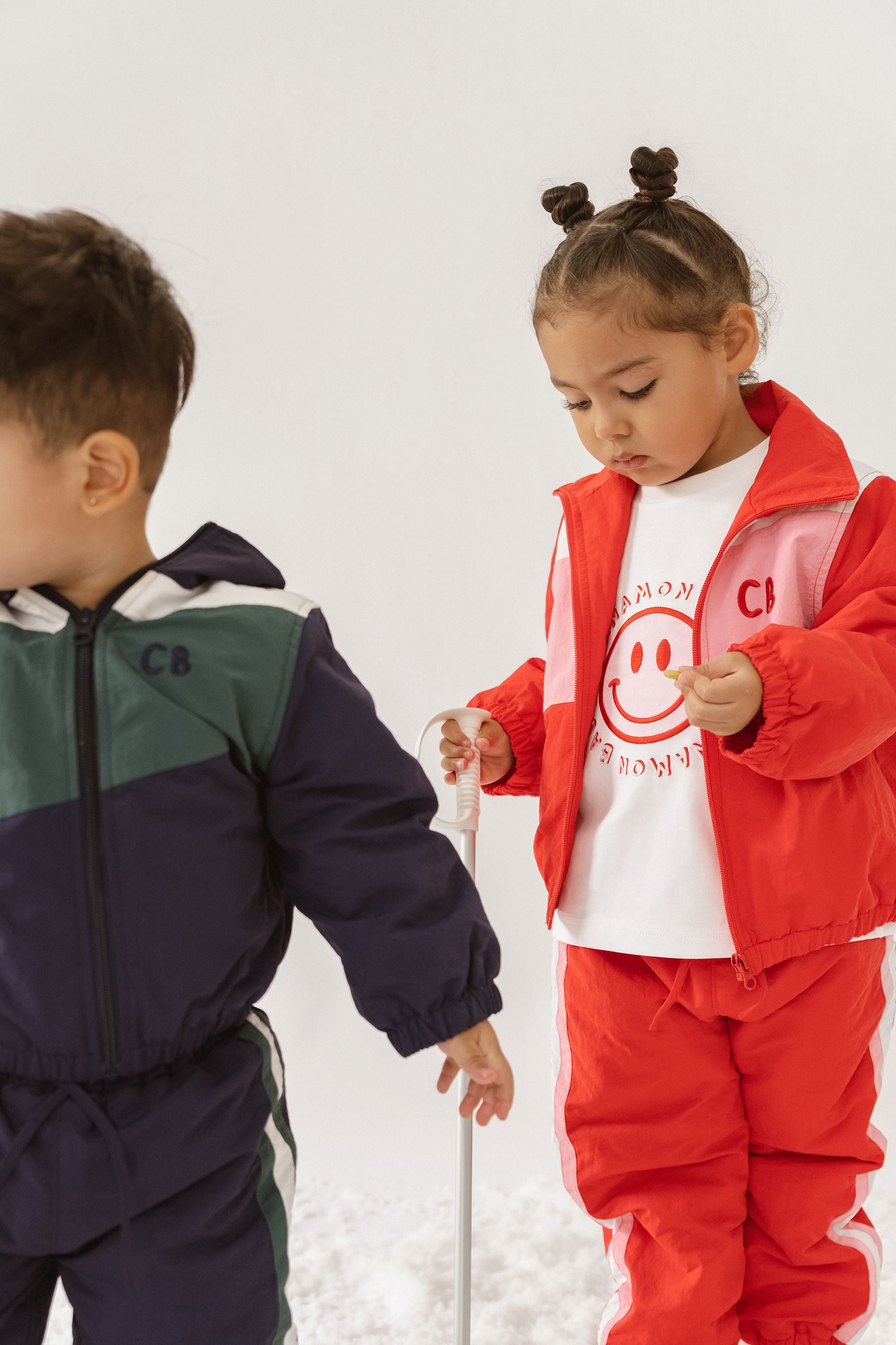 Cinnamon baby tee with white sleeves and smiley face print – unisex cotton toddler t-shirt for everyday comfort and style.