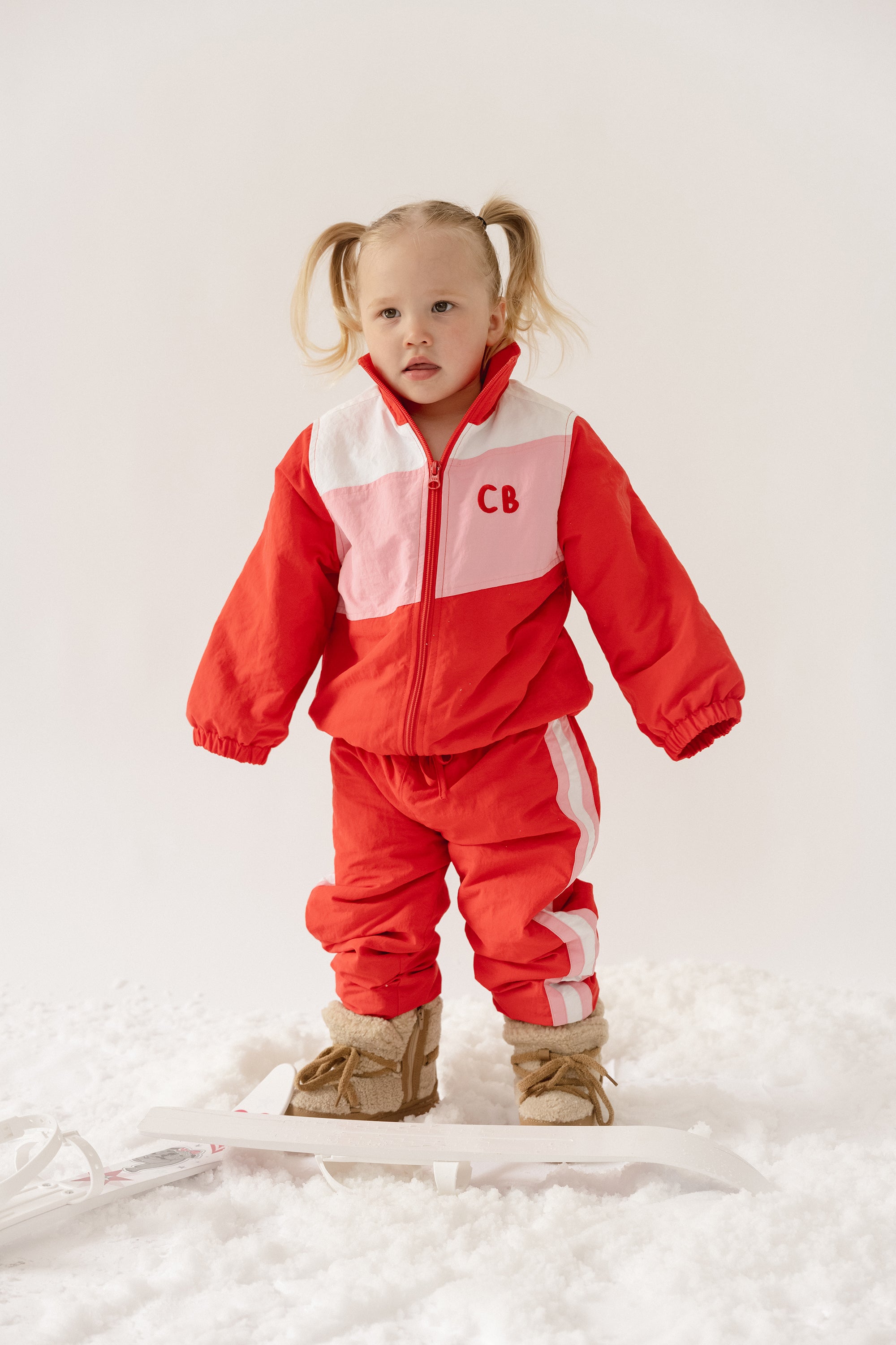 Cinnamon baby spray jacket in cherry red, lightweight and water-resistant toddler outerwear for all-weather comfort.