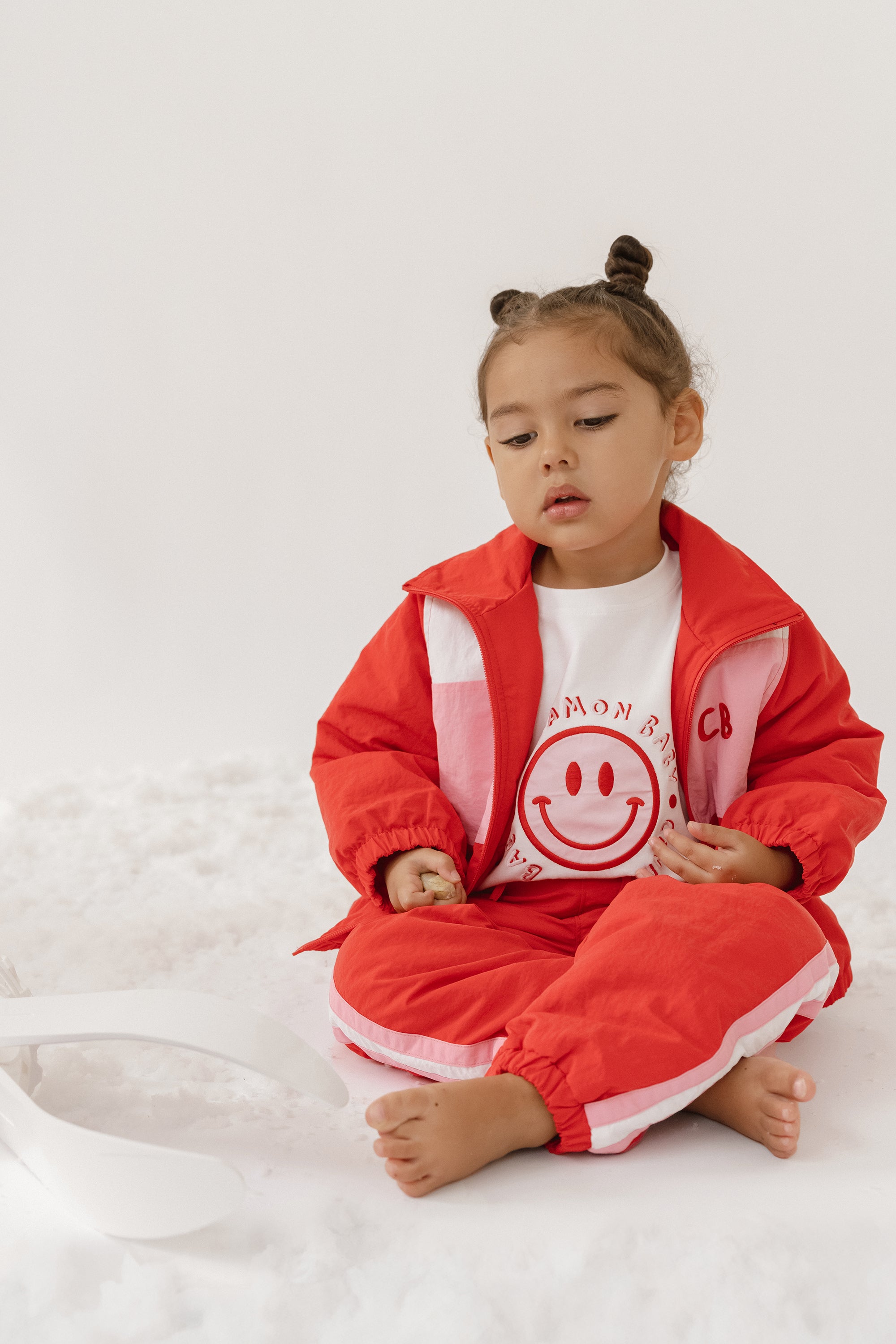 Cinnamon baby spray jacket in cherry red, lightweight and water-resistant toddler outerwear for all-weather comfort.